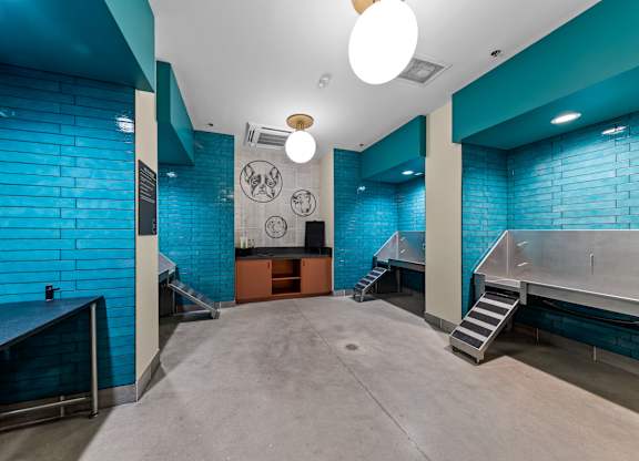 A room with a blue tiled wall and a concrete floor at Hawkins Press Apartments, Charlotte