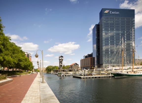 a row of boats docked in a harbor next to a tall building at 1305 Dock Street, Baltimore, 21231