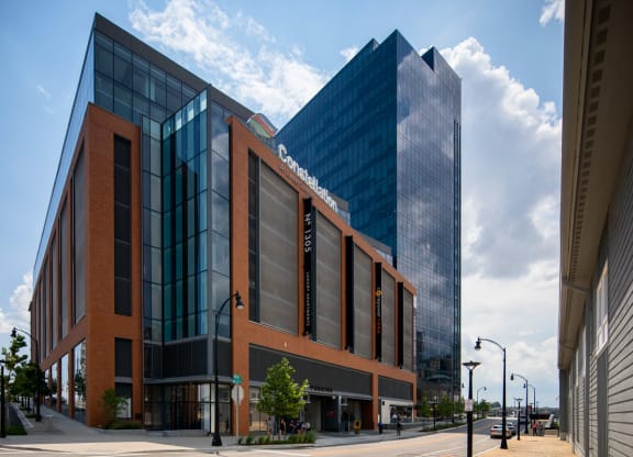 a large brick building with a glass building behind it on a street at 1305 Dock Street, Maryland