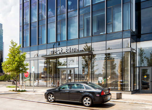 a car parked in front of a glass building at 1305 Dock Street, Maryland