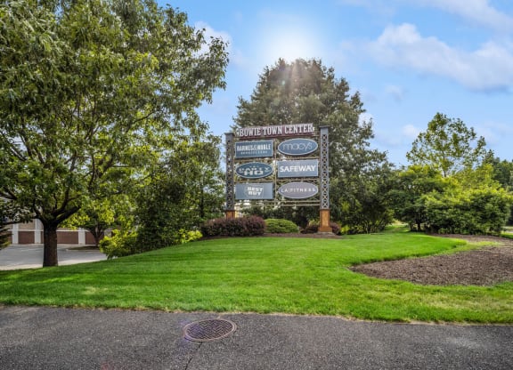 a large sign in front of a grassy area with trees at Fairmont at South Lake, Bowie, MD 20716