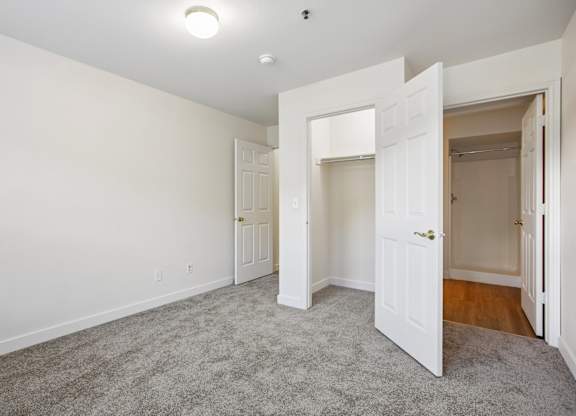 A room with white walls and a carpeted floor.