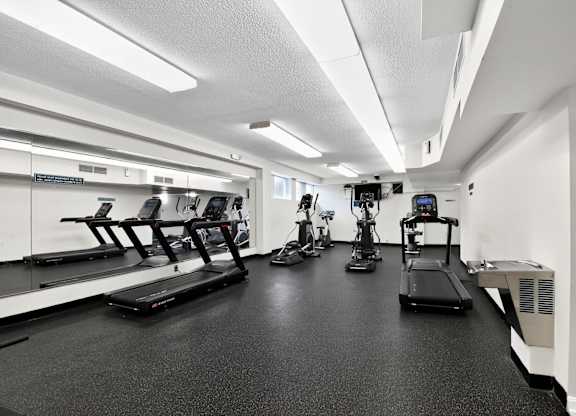 A gym with treadmills, elliptical machines, and other exercise equipment at Avondale Overlook, Hyattsville, 20782