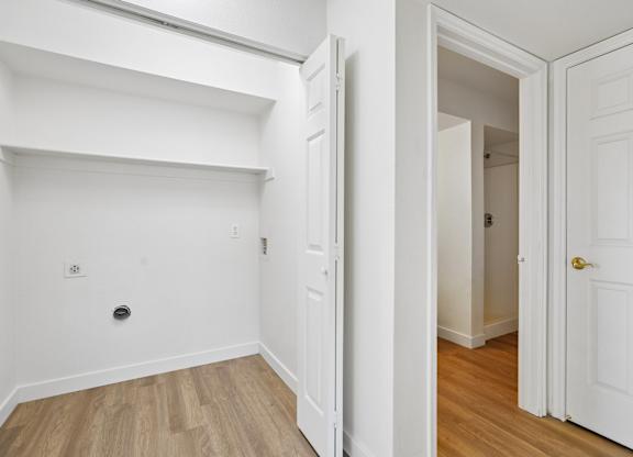 A white door is open to a hallway.