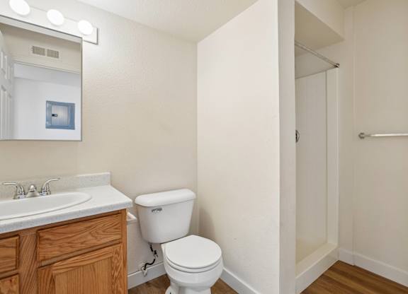 A white toilet sits next to a sink in a small bathroom.