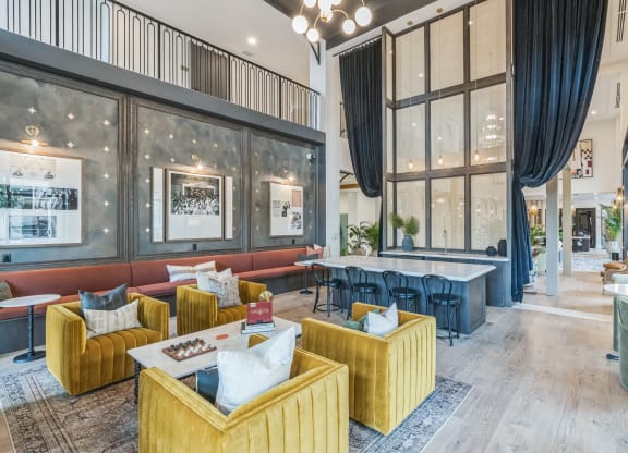 a lobby with couches and tables and large windows at La Unión, Tampa, FL 33605