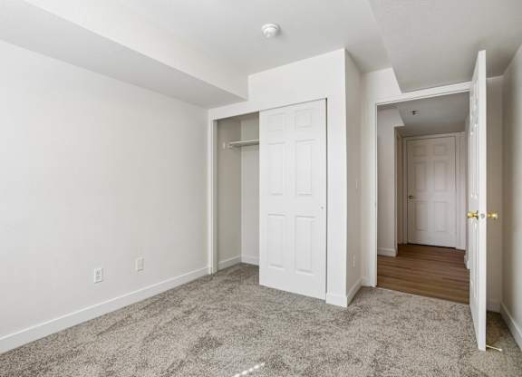 A room with a carpeted floor and white walls.