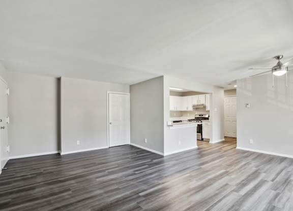 A spacious room with wooden flooring and white walls at Shenandoah Station Apartments, Triangle, Virginia