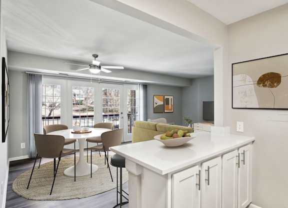 A modern kitchen with a dining table and chairs.