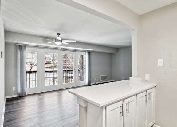 A kitchen with white cabinets and a ceiling fan at Shenandoah Station Apartments, Triangle, VA, 22172