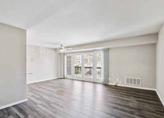 A room with wooden flooring and a sliding glass door at Shenandoah Station Apartments, Virginia 22172