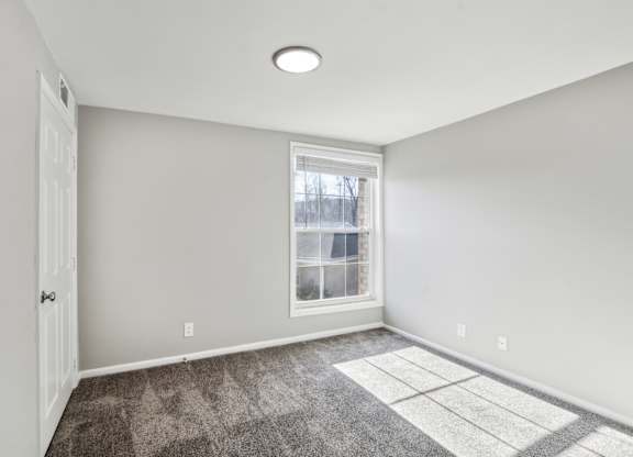 A room with a window and a rug on the floor at Shenandoah Station Apartments, Triangle, VA, 22172