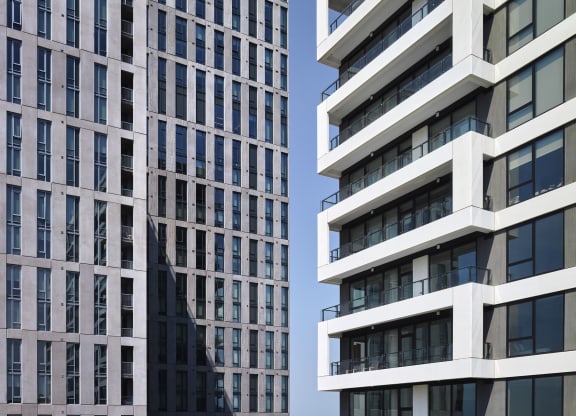 a close up of two tall buildings with balconies at The Boro, Tysons, VA