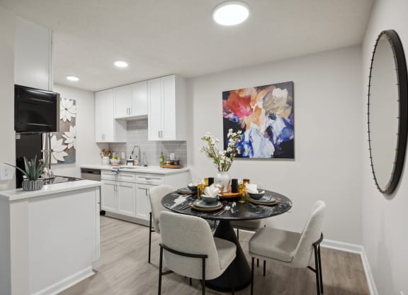our apartments offer a dining room and kitchen with white cabinets and appliances at St. Andrews Reserve, Wilmington, North Carolina