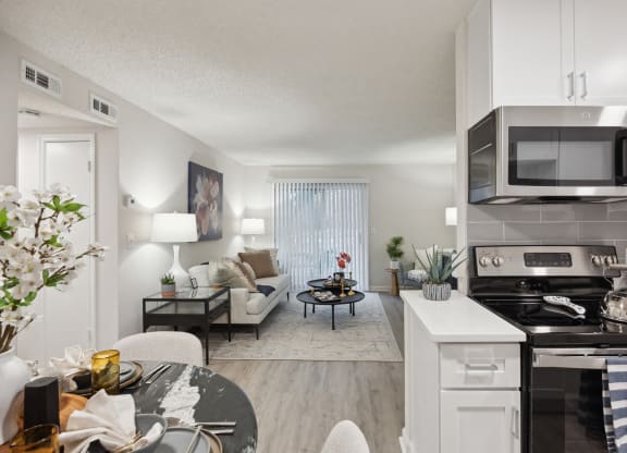 our apartments offer a spacious living room with a kitchen and dining area at St. Andrews Reserve, North Carolina, 28412