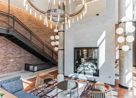 a living room with a fireplace and a large chandelier at Hawkins Press, Charlotte