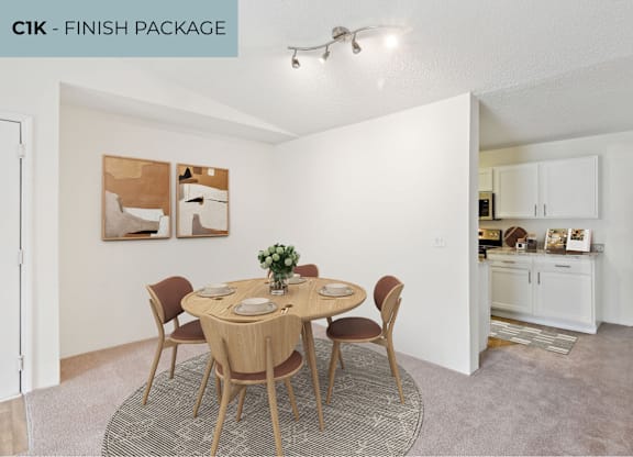 A dining room with a round table set for four.