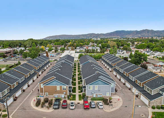A parking lot with cars and a building in the background.