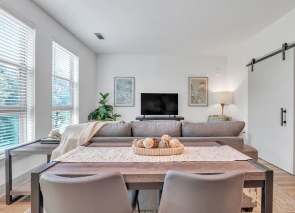 a living room with a couch and a table with chairs
