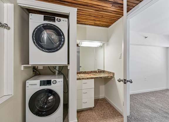 A small laundry room with a washer and dryer in it.