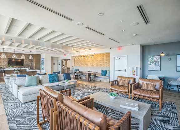A spacious living room with a variety of seating options and a fireplace.