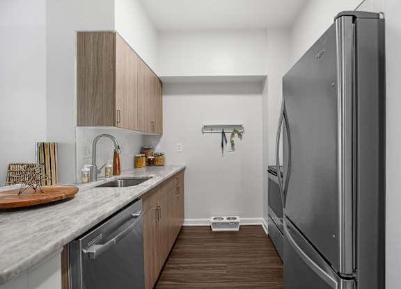 A modern kitchen with a refrigerator on the right.