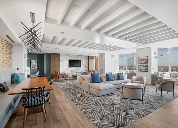 A modern living room with a wooden floor and a large window.