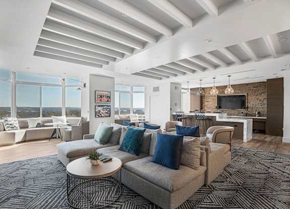 A living room with a grey couch and a coffee table.