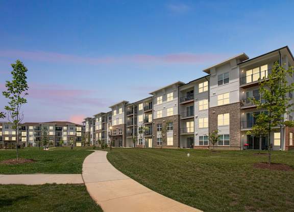 A long building with a walkway in front of it.