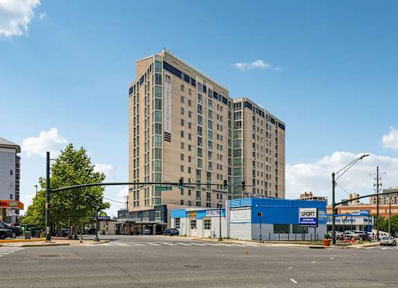 A large building with a blue Sport store in front.