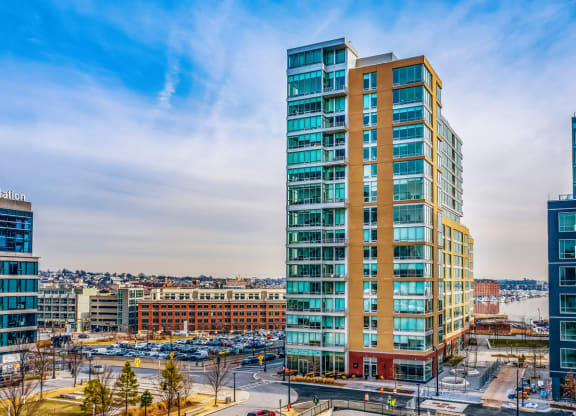 an aerial view of an office building with a city in the background at 1405 Point Street Apartments in Baltimore, MD
