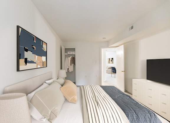 A bedroom with a bed, a lamp, and a painting on the wall at The Fields of Rockville, Rockville, 20850