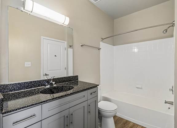 A bathroom with a sink, toilet, and bathtub.