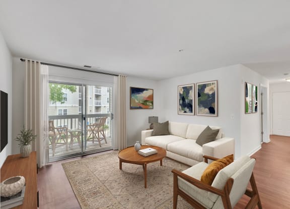 a living room with white furniture and a sliding glass door to a balcony at Sanger Place, Lorton, 22079