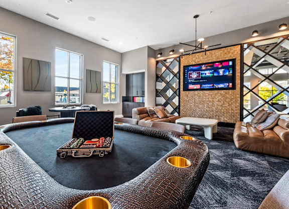 a living room with a round couch and a television  at South and Hollis, North Carolina
