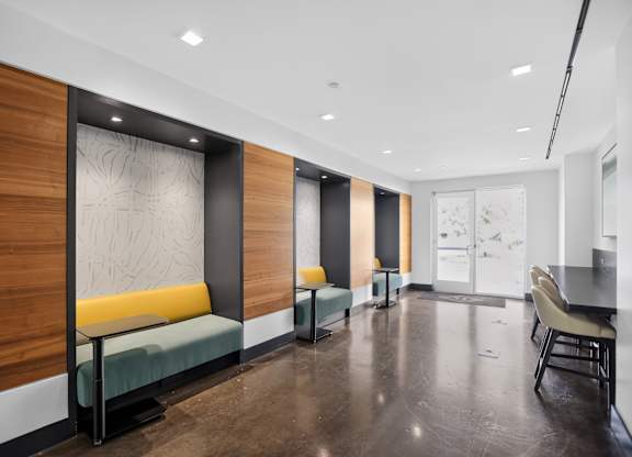 A long hallway with a bench and a table.