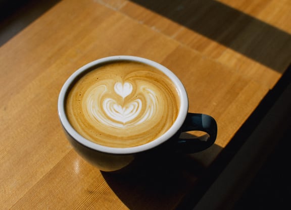 a cup of coffee with a heart drawn in the foam at Allied Harbor Point, Baltimore, 21231
