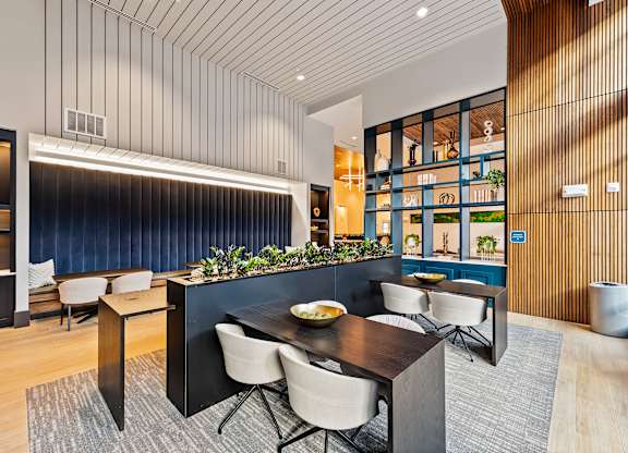 Modern dining and coworking area with a dark table and chairs  at Preston Ridge in Cary, NC.
