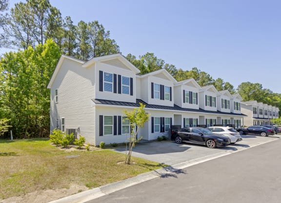 a row of houses with cars parked in front of them  at Waverly Place, North Charleston