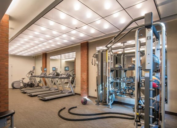 a gym with weights and cardio equipment in a building at Reed Row, Washington, 20009