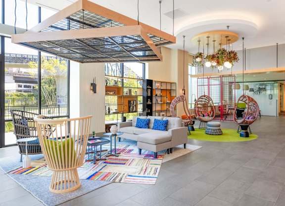 the lobby of a library with chairs and couches and a table at The Chase at Bryant Street, Washington, DC 20002