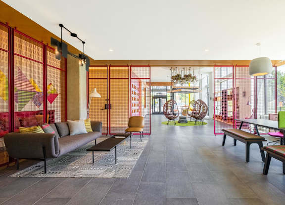 a living room with a couch and chairs and a ping pong table  at Coda at Bryant Street, Washington, DC