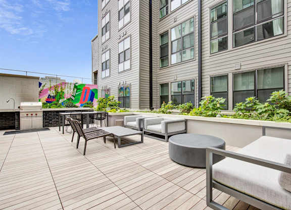 a communal patio with seating and tables in front of a building at Coda at Bryant Street, Washington