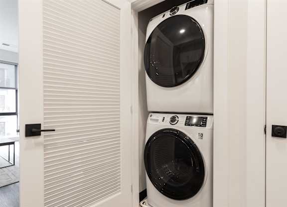 a front loading washer and dryer in a laundry room at Coda at Bryant Street, Washington DC