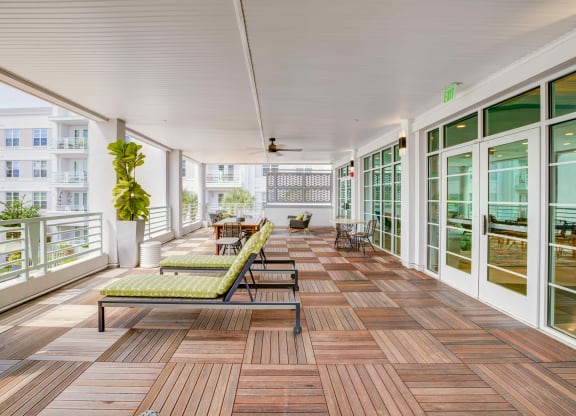 a large porch with wood floors and glass doors at Delamarre at Celebration, Celebration, 34747