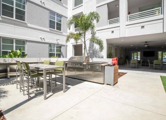 a patio with a grill and tables and chairs at Delamarre at Celebration, Florida, 34747