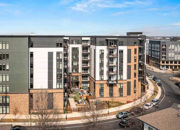 A modern apartment complex with a mix of brick and panel buildings at Hawkins Press Apartments, Charlotte, NC, 28203