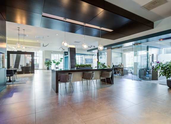 A modern dining area with a long table and chairs.