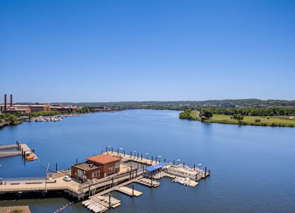 A dock with a building on it is in the middle of a body of water.