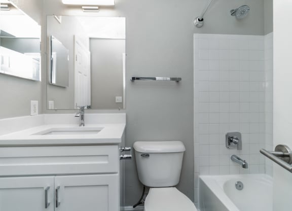 a white bathroom with a toilet and a sink at The Fields at Lorton Station, Lorton, VA